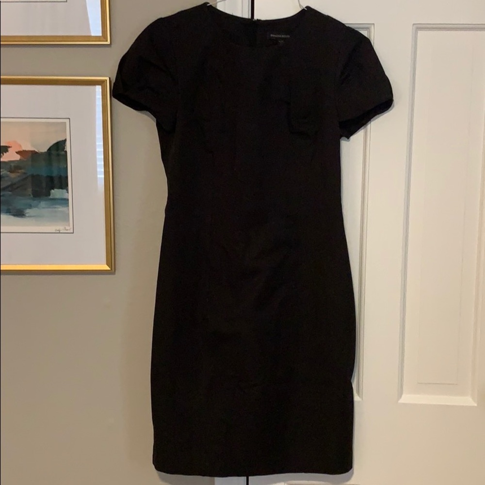 Black dress with pin tuck sleeves, zipper detail